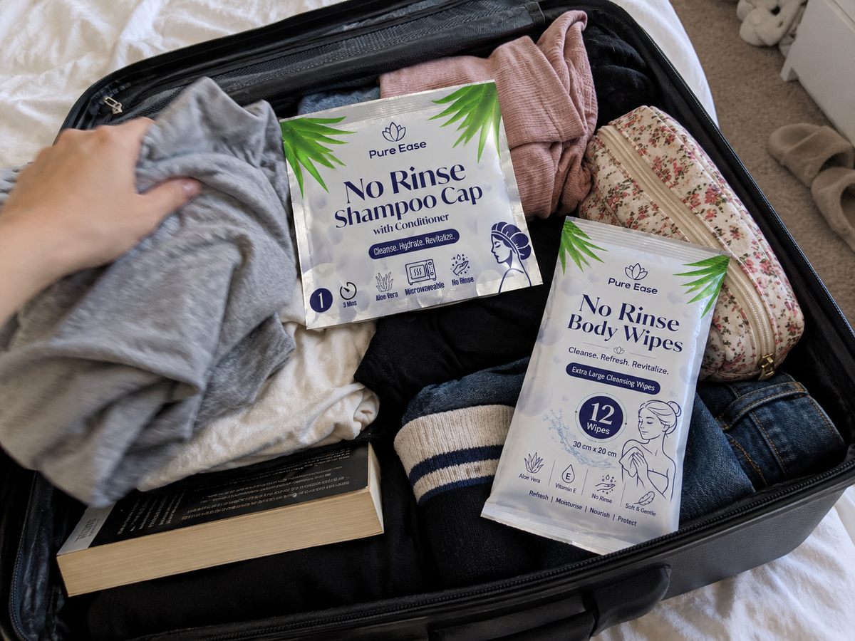 PureEase Shampoo Caps and Body Wipes packed with clothes for a trip